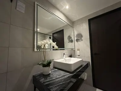 a bathroom with a sink and a mirror at Bertam Resort & Water Park Penang in Kepala Batas