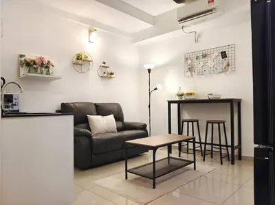 a living room with a couch and a table at 【NEW】Cozy&Warm Studio@Juru Sentral Icon City in Bukit Mertajam