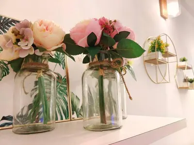 three glass vases with flowers in them on a shelf at 【NEW】Cozy&Warm Studio@Juru Sentral Icon City in Bukit Mertajam