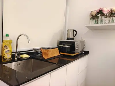 a kitchen counter with a sink and a microwave at 【NEW】Cozy&Warm Studio@Juru Sentral Icon City in Bukit Mertajam