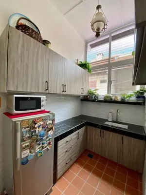 a kitchen with a refrigerator and a microwave at Pertak Siring at Kuala Kubu Bharu in Kuala Kubu Baharu