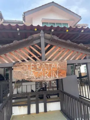 a sign on a fence in front of a building at NO 121 NAZIRIN HOMESTAY TMN DESA MANJUNG in Lumut