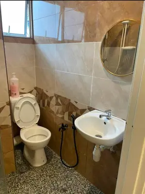 a bathroom with a sink and a toilet and a mirror at Cameron Homestay klasik Adik Aisyah in Cameron Highlands