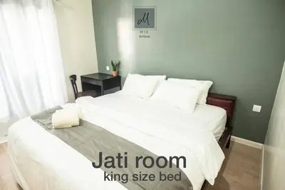 a bedroom with a large bed with white sheets and pillows at M12 Homestay, Butterworth in Butterworth