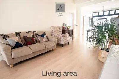 a living room with a couch and two chairs at M12 Homestay, Butterworth in Butterworth