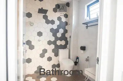 a bathroom with a white toilet and a shower at M12 Homestay, Butterworth in Butterworth