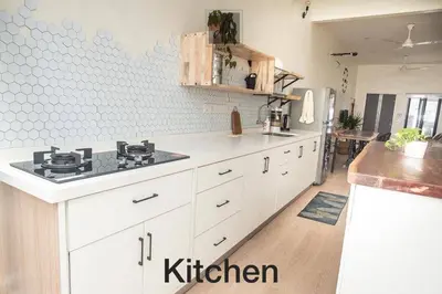 a kitchen with white cabinets and a stove in it at M12 Homestay, Butterworth in Butterworth
