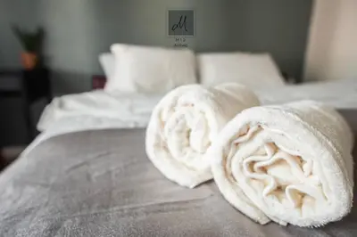 two rolled up towels on top of a bed at M12 Homestay, Butterworth in Butterworth