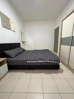 a bedroom with a bed in a white room at Izwana Muslim Homestay in Tanah Rata