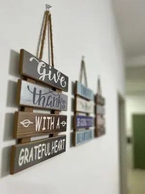 a group of signs hanging on a wall at Izwana Muslim Homestay in Tanah Rata