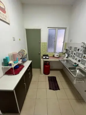 a kitchen with a sink and a counter top at Izwana Muslim Homestay in Tanah Rata