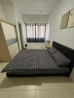 a large bed in a room with a window at Izwana Muslim Homestay in Tanah Rata