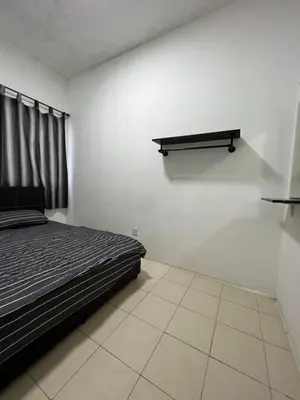 a bedroom with a bed and a shelf on the wall at Izwana Muslim Homestay in Tanah Rata