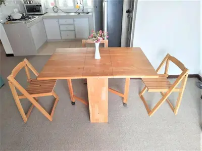 a wooden table with two chairs and a vase with flowers at Fraser Hill Silverpart Resort B2-6-1 Forest View High Floor No Lift in Bukit Fraser