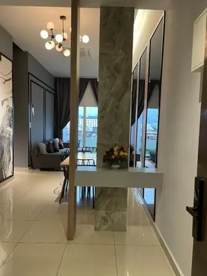 a living room with a table and a couch at R&C Guesthouse in Ipoh