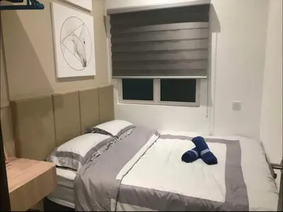 a bedroom with a large bed and a window at R&C Guesthouse in Ipoh