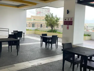 a group of tables and chairs in a building at R&C Guesthouse in Ipoh