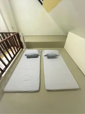 two beds in a room next to a room with at Fraser Hill Silverpart Resort A3-6-3A Best View With Lift in Bukit Fraser