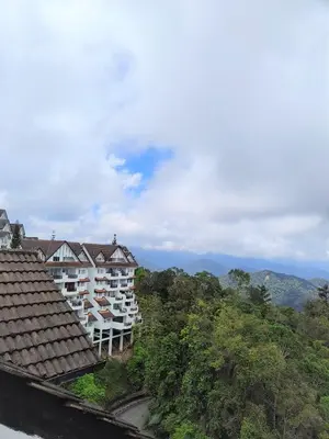 a view of a building with mountains in the background at Fraser Hill Silverpart Resort A3-6-3A Best View With Lift in Bukit Fraser