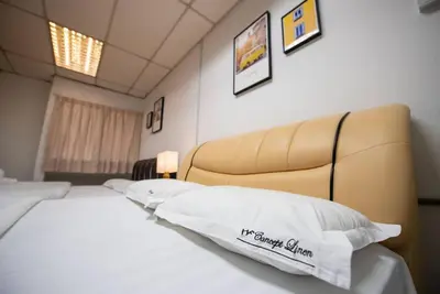 a hotel room with a bed and a head board at De Luma (The Rumah)@3bedroom (Sunflower) in Bukit Mertajam