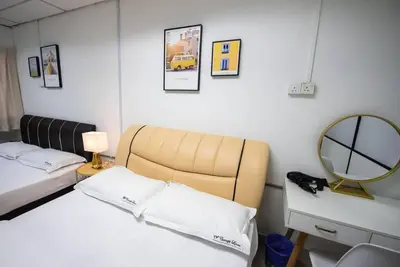 a small bedroom with two beds and a mirror at De Luma (The Rumah)@3bedroom (Sunflower) in Bukit Mertajam