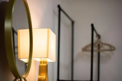 a lamp with a mirror on a wall at De Luma (The Rumah)@3bedroom (Sunflower) in Bukit Mertajam