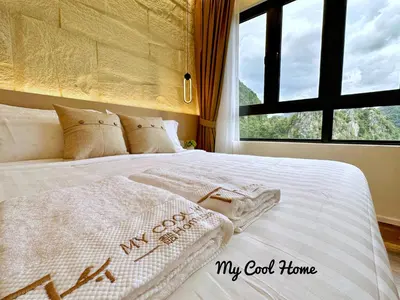 a bedroom with a white bed with a window at Sunway Onsen Hotsprings with Theme Park View, Sunway Lost World in Ipoh