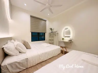 two beds in a bedroom with a ceiling fan at Sunway Onsen Hotsprings with Theme Park View, Sunway Lost World in Ipoh
