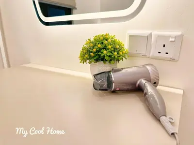 a hair dryer on a wall with a potted plant at Sunway Onsen Hotsprings with Theme Park View, Sunway Lost World in Ipoh