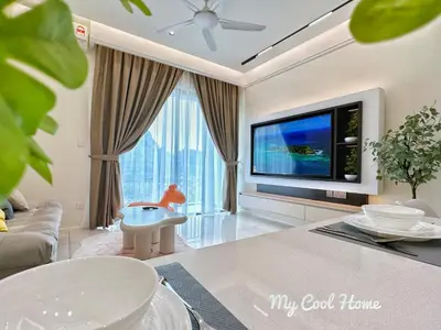 a living room with a large tv and a couch at Sunway Onsen Hotsprings with Theme Park View, Sunway Lost World in Ipoh