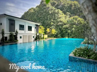 a swimming pool in front of a house and a mountain at Sunway Onsen Hotsprings with Theme Park View, Sunway Lost World in Ipoh