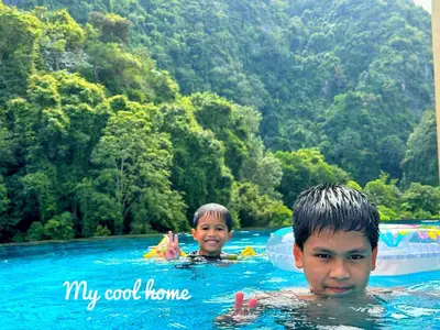 two boys in the water at a swimming pool at Sunway Onsen Hotsprings with Theme Park View, Sunway Lost World in Ipoh