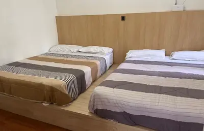 two beds sitting next to each other in a room at Cameron Crown Imperial Court @ Brinchang in Brinchang