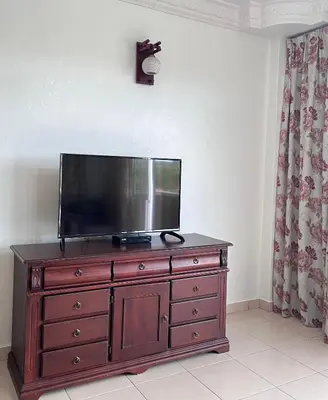a flat screen tv sitting on top of a dresser at Cameron Crown Imperial Court @ Brinchang in Brinchang