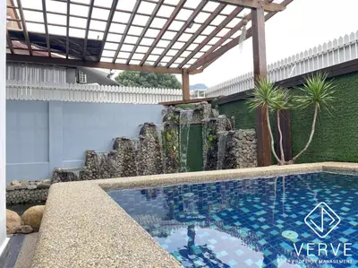 a swimming pool in front of a building with a pergola at Ipoh 27 Private Pool Villa By Verve EECH118 in Ipoh