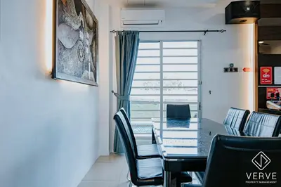 a dining room with a table and chairs and a window at Ipoh 27 Private Pool Villa By Verve EECH118 in Ipoh