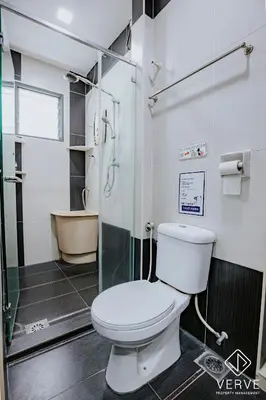 a bathroom with a toilet and a glass shower at Ipoh 27 Private Pool Villa By Verve EECH118 in Ipoh