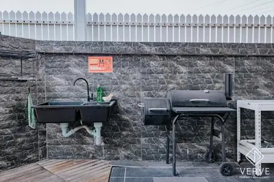 a stone wall with a sink and a grill at Ipoh 27 Private Pool Villa By Verve EECH118 in Ipoh