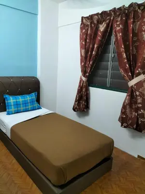 a bedroom with a bed and a window with curtains at KHAIRUL HOMESTAY PANGSAPURI SUTERA SEBERANG JAYA in Kampong Telok