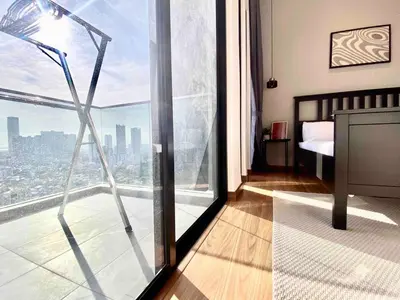 a bedroom with a view of a city from a window at Beacon Executive Suites #Warmth #SkyPool #Georgetown #5pax #2BR 2bath #2Queen 1Single #Quality well maintained #Private host in George Town