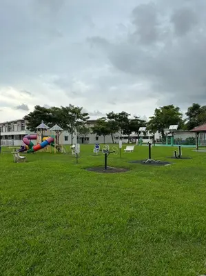 a park with a bunch of playground equipment in the grass at Ulike~home stay~Setia residen~4room in Kampong Selamat