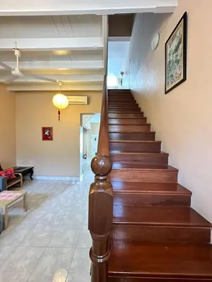 a staircase in a living room with a stair case at Popus Heritage Townhouse, Georgetown in George Town