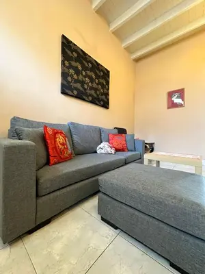 a living room with a couch and a table at Popus Heritage Townhouse, Georgetown in George Town