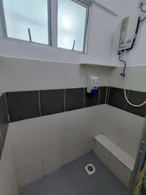 an empty bathroom with a window and a toilet at Cameron Hill Homestay in Tanah Rata