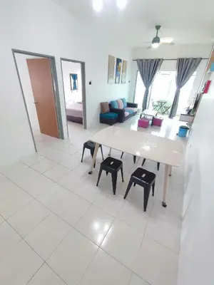 a living room with a table and some chairs at Cameron Hill Homestay in Tanah Rata