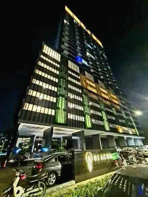 a large building with a car parked in front of it at Beacon Executive Suites - Penang in George Town