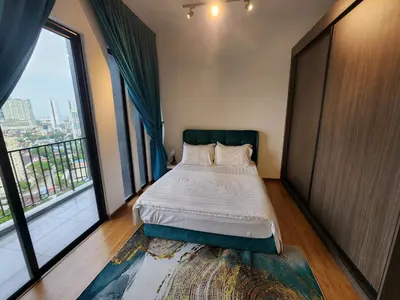 a bedroom with a bed and a large window at Beacon Executive Suites - Penang in George Town