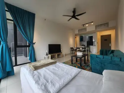 a bedroom with a bed and a living room at Beacon Executive Suites - Penang in George Town