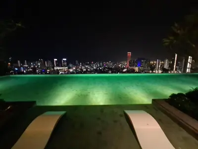 a bench with a view of the city at night at Beacon Executive Suites - Penang in George Town