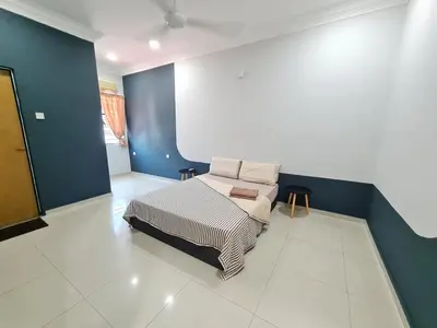 a bedroom with a bed and a blue wall at Air-home M9 Simpang near Aulong Econsave, 4BR, 10pax, Netflix in Taiping